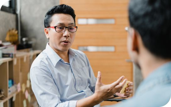 Two people having a conversation in a mail room